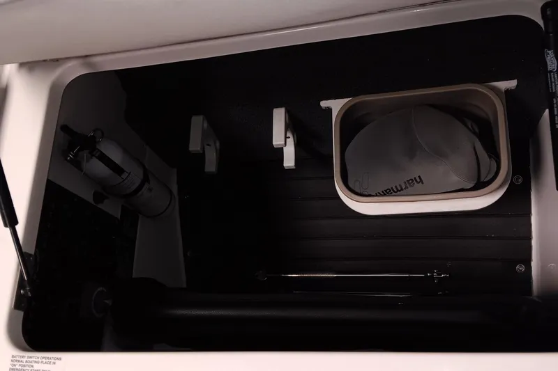 Slide: The Image of Storage compartment in 2023 Cobalt R4 boat with fire extinguisher and hat. - 10