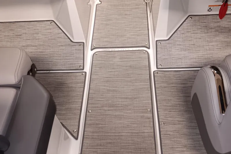 Slide: The Image of 2023 Cobalt R4 boat interior with gray textured flooring and sleek seating. - 12