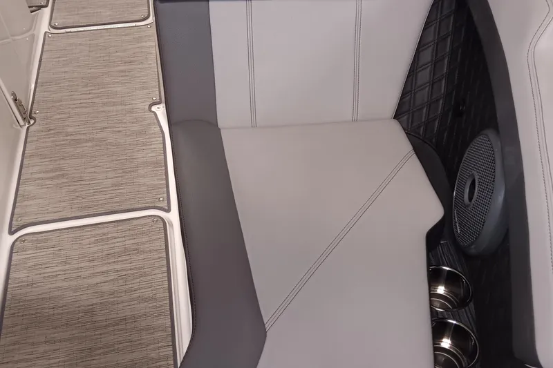 Slide: The Image of 2023 Cobalt R4 boat interior with cushioned seating and cup holders. - 14