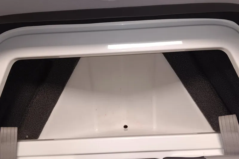 Slide: The Image of 2023 Cobalt R4 boat interior storage compartment with white and gray accents. - 21