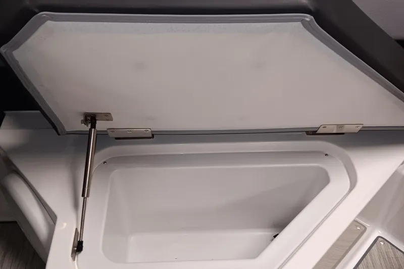 Slide: The Image of Open storage compartment in 2023 Cobalt R4 boat, featuring hydraulic hinge support. - 8