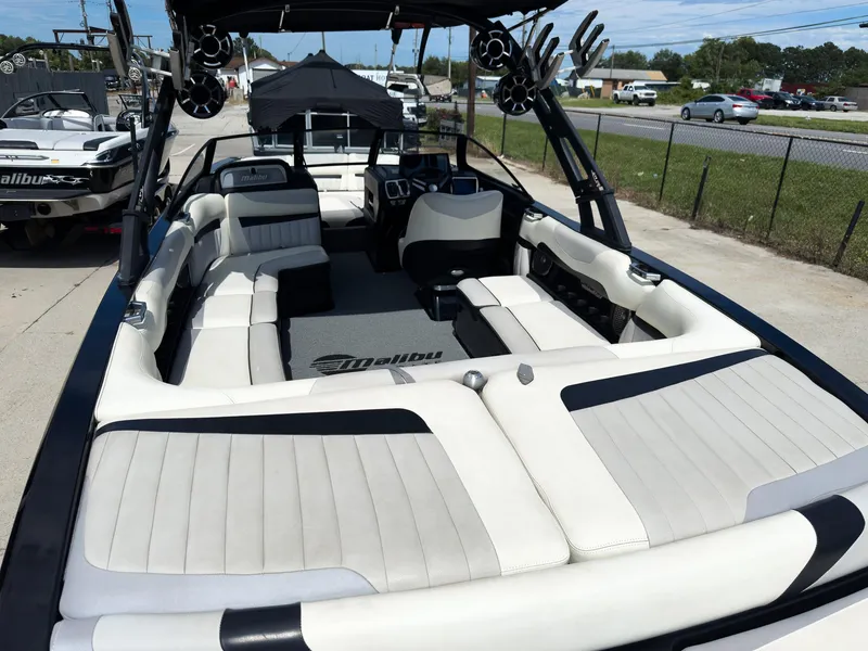Slide: The Image of 2015 Malibu Wakesetter 24 MXZ boat with spacious white interior seating. - 12