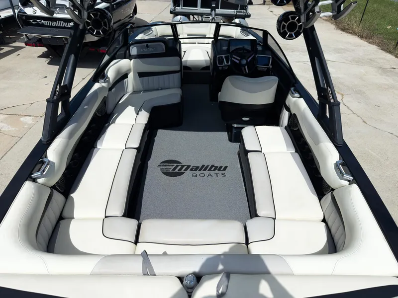 Slide: The Image of 2015 Malibu Wakesetter 24 MXZ interior with white seating and modern dashboard. - 13