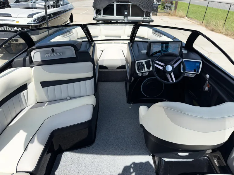 Slide: The Image of 2015 Malibu Wakesetter 24 MXZ interior with sleek seating and modern dashboard controls. - 14