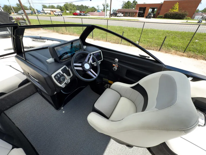 Slide: The Image of 2015 Malibu Wakesetter 24 MXZ boat interior with steering wheel and dashboard controls. - 15