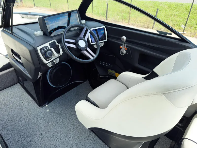 Slide: The Image of 2015 Malibu Wakesetter 24 MXZ cockpit with modern steering and control panel. - 16