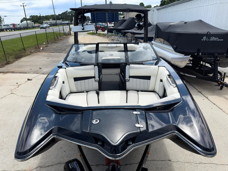 Slide: The Image of 2015 Malibu Wakesetter 24 MXZ boat with sleek black and white interior design. - 2