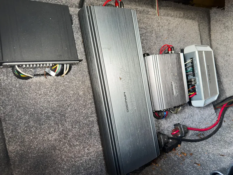 Slide: The Image of Audio amplifiers and wiring inside a 2015 Malibu Wakesetter 24 MXZ boat. - 21