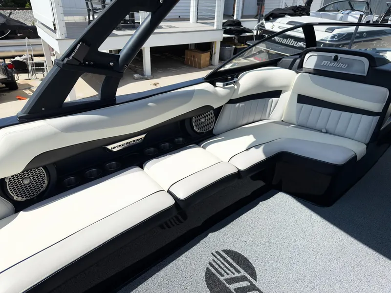 Slide: The Image of 2015 Malibu Wakesetter 24 MXZ interior with white leather seating and modern design. - 24