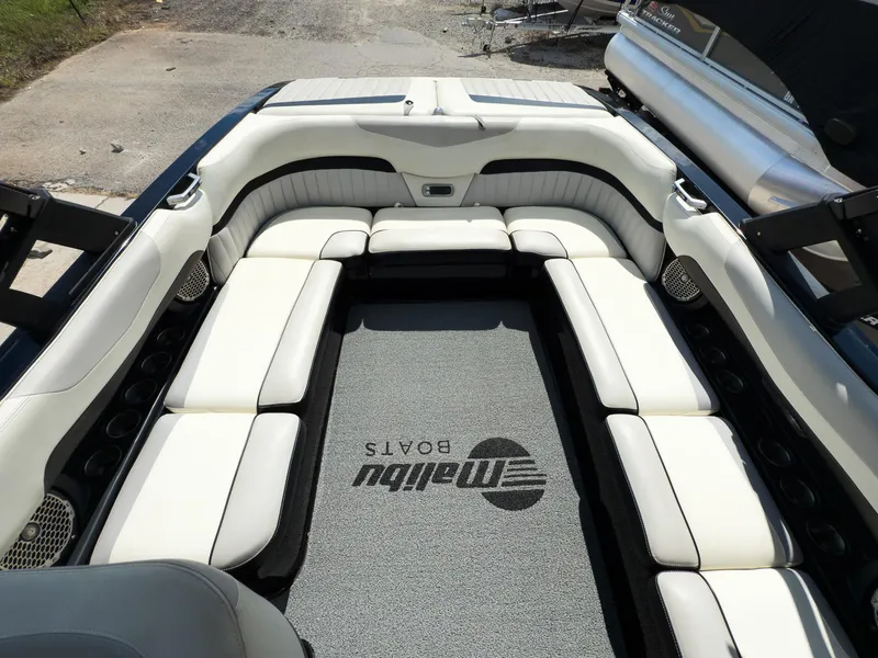 Slide: The Image of 2015 Malibu Wakesetter 24 MXZ interior with white seating and branded carpet. - 26