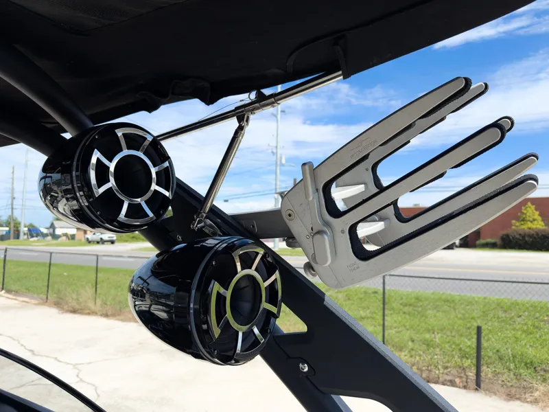 Slide: The Image of 2015 Malibu Wakesetter 24 MXZ boat speakers and wakeboard rack under blue sky. - 28
