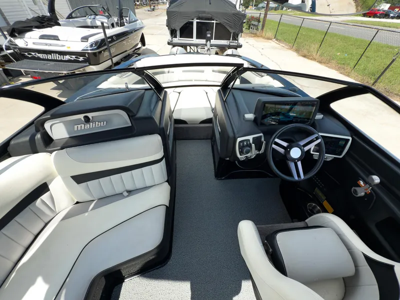 Slide: The Image of 2015 Malibu Wakesetter 24 MXZ interior with sleek dashboard and comfortable seating. - 30