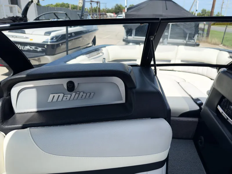 Slide: The Image of Interior view of a 2015 Malibu Wakesetter 24 MXZ boat with white seating. - 31