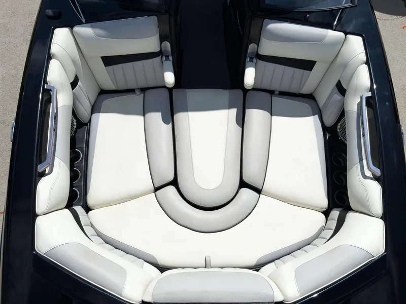 Slide: The Image of 2015 Malibu Wakesetter 24 MXZ boat interior with white cushioned seating. - 35