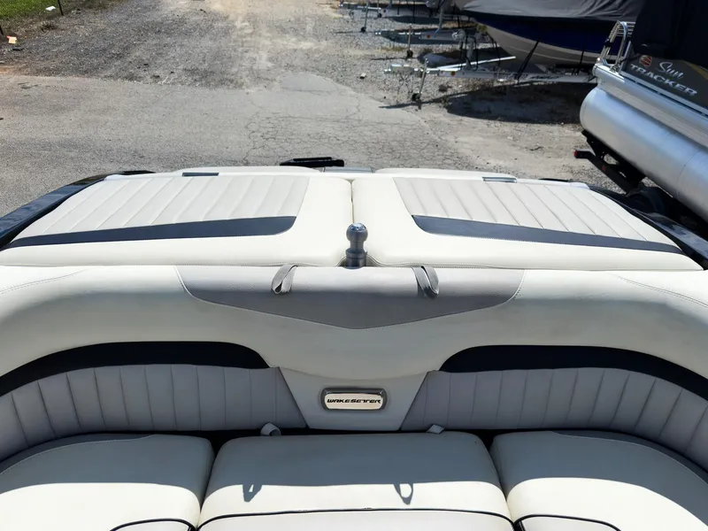 Slide: The Image of 2015 Malibu Wakesetter 24 MXZ boat interior with cushioned seating and sleek design. - 40