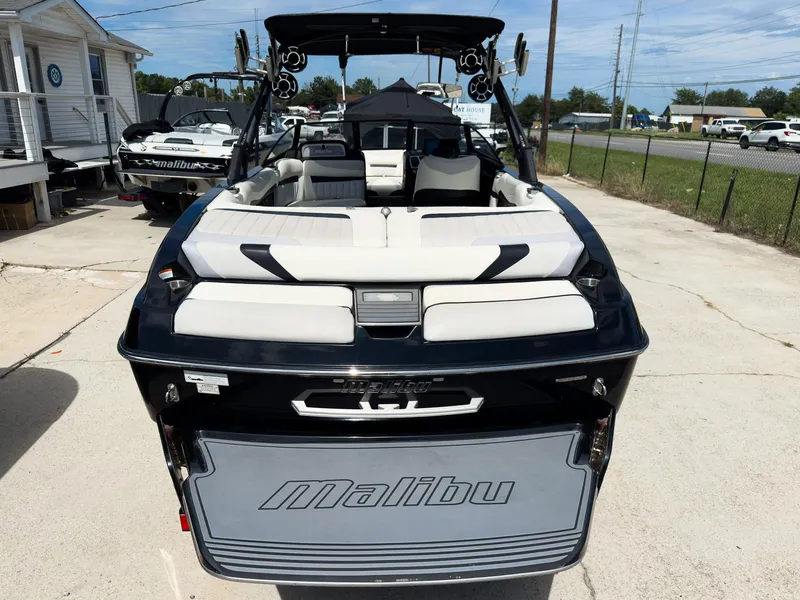 Slide: The Image of 2015 Malibu Wakesetter 24 MXZ boat, rear view, parked outdoors. - 5