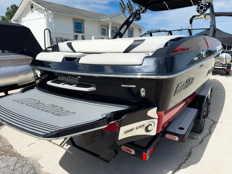 Slide: The Image of 2015 Malibu Wakesetter 24 MXZ boat with Surf Gate, parked on a trailer. - 7