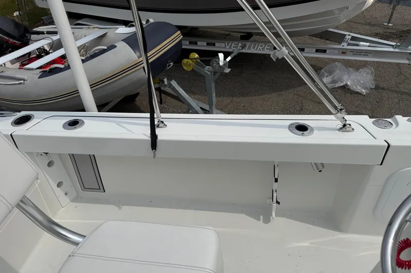 Slide: The Image of Interior view of a 2025 Parker 181 SHOAL boat, featuring seating and rod holders. - 6