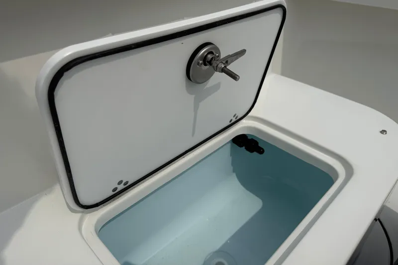 Slide: The Image of Parker 181 SHOAL 2025 boat compartment with open hatch and water inside. - 9