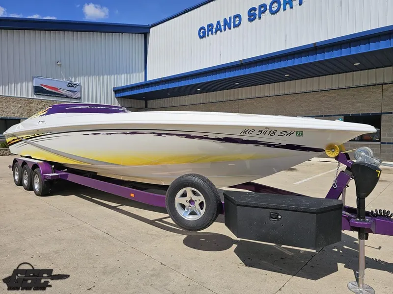 Slide: The Image of 2003 Sunsation 32 Dominator boat on trailer outside Grand Sport Center. - 13