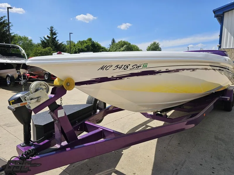 Slide: The Image of 2003 Sunsation 32 Dominator boat on a purple trailer, parked outdoors. - 15