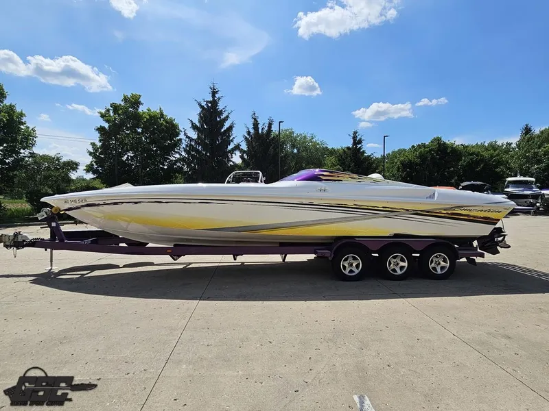 Slide: The Image of 2003 Sunsation 32 Dominator speedboat on trailer under clear blue sky. - 19