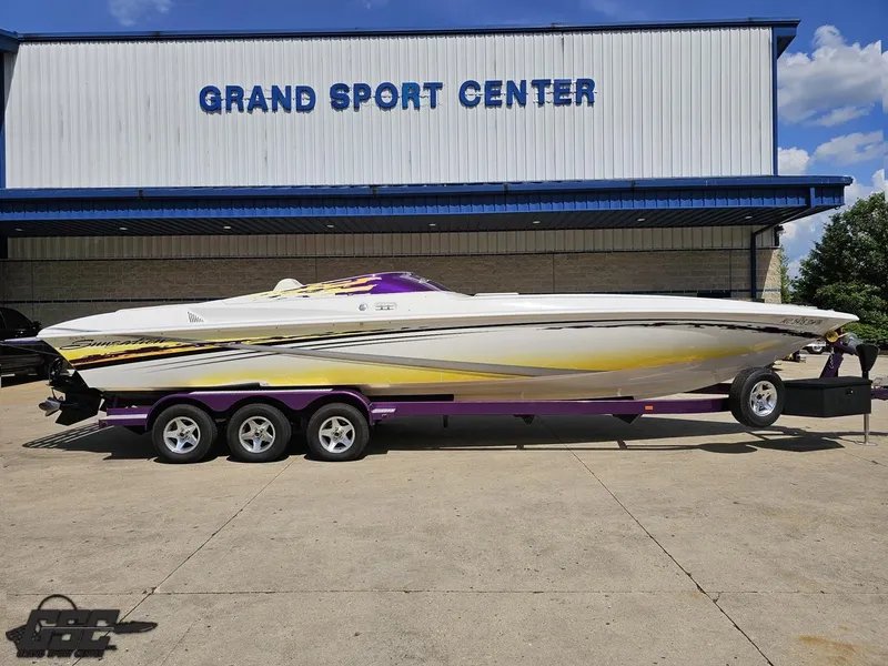 Slide: The Image of 2003 Sunsation 32 Dominator boat on trailer at Grand Sport Center. - 2