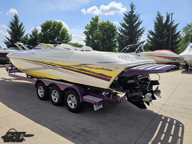 Slide: The Image of 2003 Sunsation 32 Dominator speedboat on trailer, parked outdoors under a clear sky. - 25