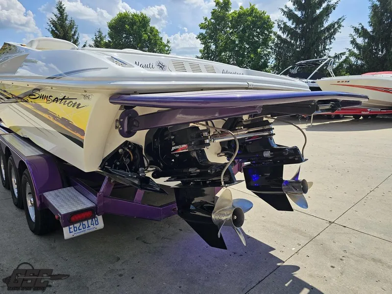 Slide: The Image of 2003 Sunsation 32 Dominator boat with dual propellers on a trailer. - 28