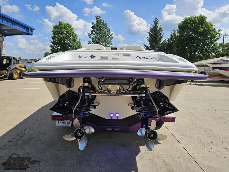 Slide: The Image of 2003 Sunsation 32 Dominator boat, rear view with dual propellers, parked outdoors. - 29