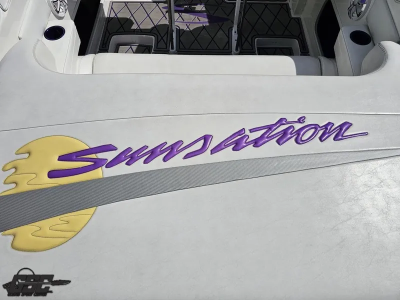 Slide: The Image of 2003 Sunsation 32 Dominator boat interior with logo and stylish upholstery design. - 43