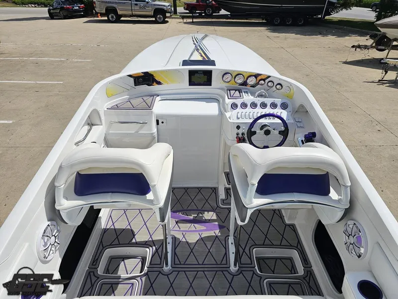 Slide: The Image of 2003 Sunsation 32 Dominator boat interior with dual seats and modern dashboard controls. - 47
