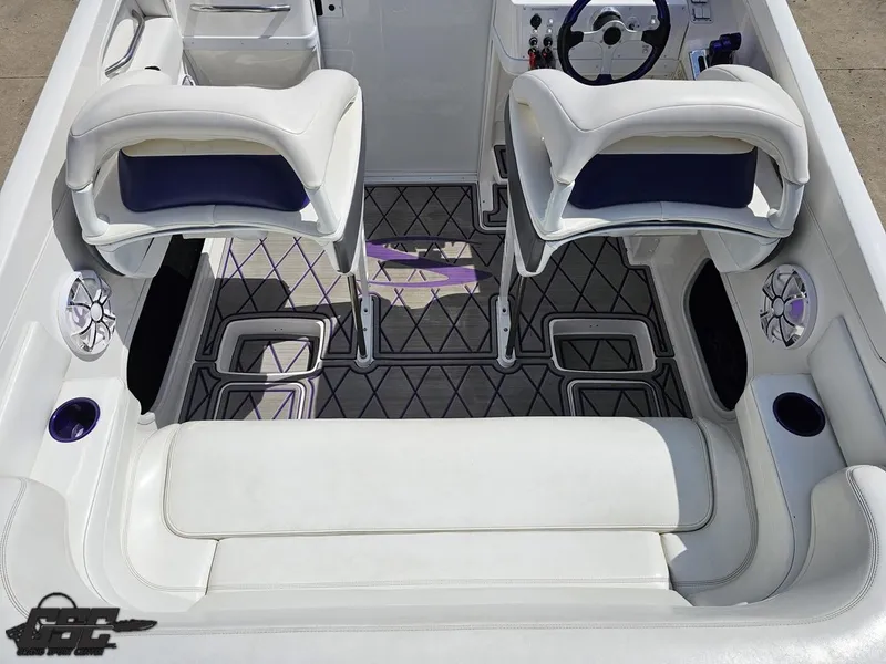 Slide: The Image of 2003 Sunsation 32 Dominator boat interior with white seating and modern dashboard. - 48