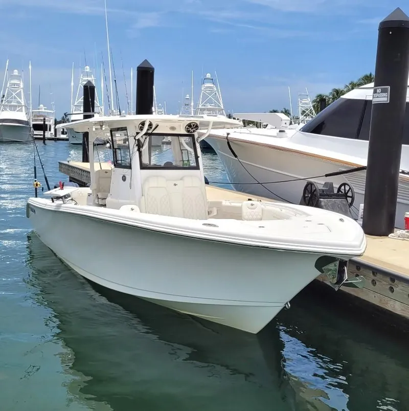 The Image of 2022 Sea Pro 320 DLX Center Console boat docked in a marina. - 0