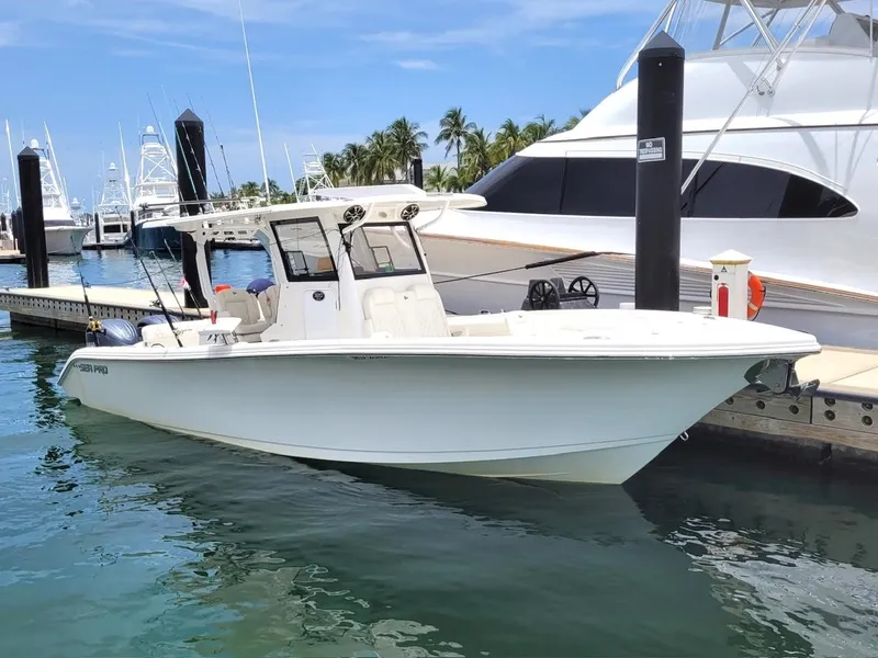 Slide: The Image of 2022 Sea Pro 320 DLX Center Console boat docked at marina. - 1