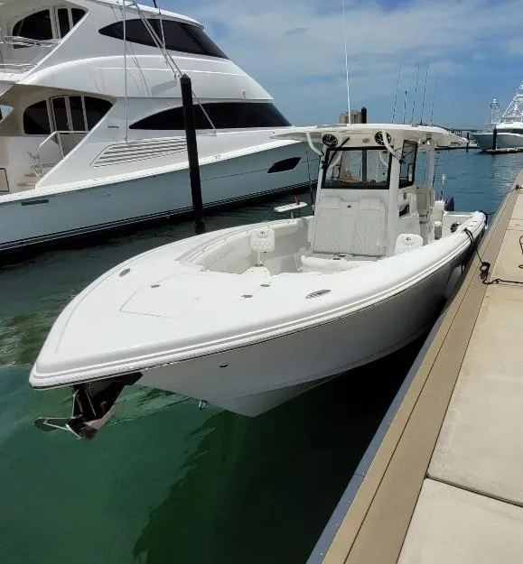Slide: The Image of 2022 Sea Pro 320 DLX Center Console boat docked at marina. - 3