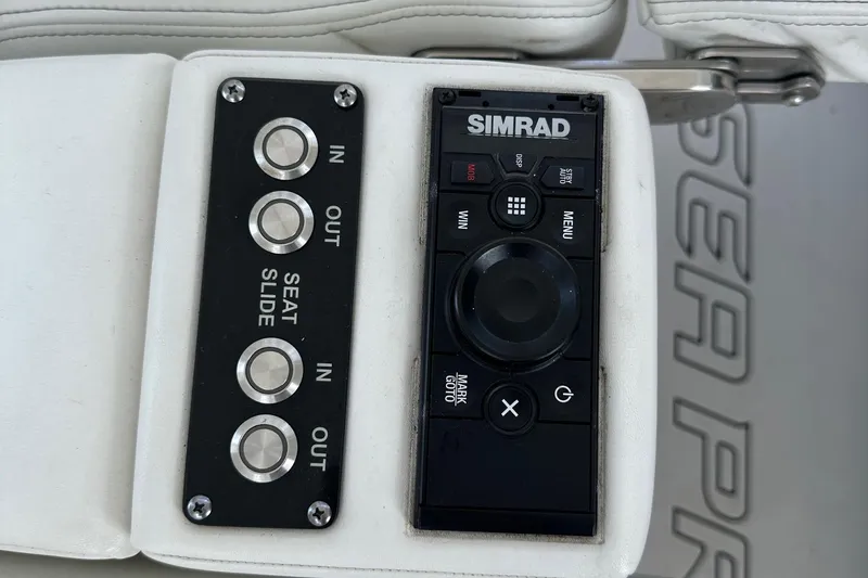Slide: The Image of Control panel of 2022 Sea Pro 320 DLX Center Console with Simrad system and seat adjustment. - 36