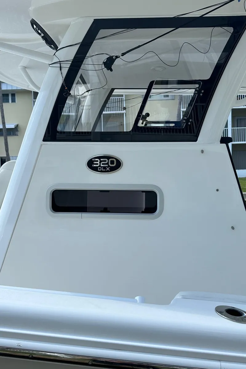 Slide: The Image of 2022 Sea Pro 320 DLX Center Console boat, rear view with model badge. - 38