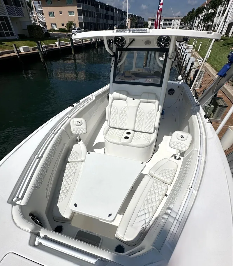 Slide: The Image of 2022 Sea Pro 320 DLX Center Console boat docked, featuring spacious seating and modern design. - 5