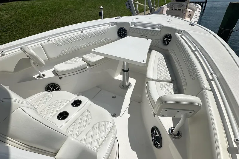 Slide: The Image of 2022 Sea Pro 320 DLX Center Console boat with luxurious white seating and table. - 7