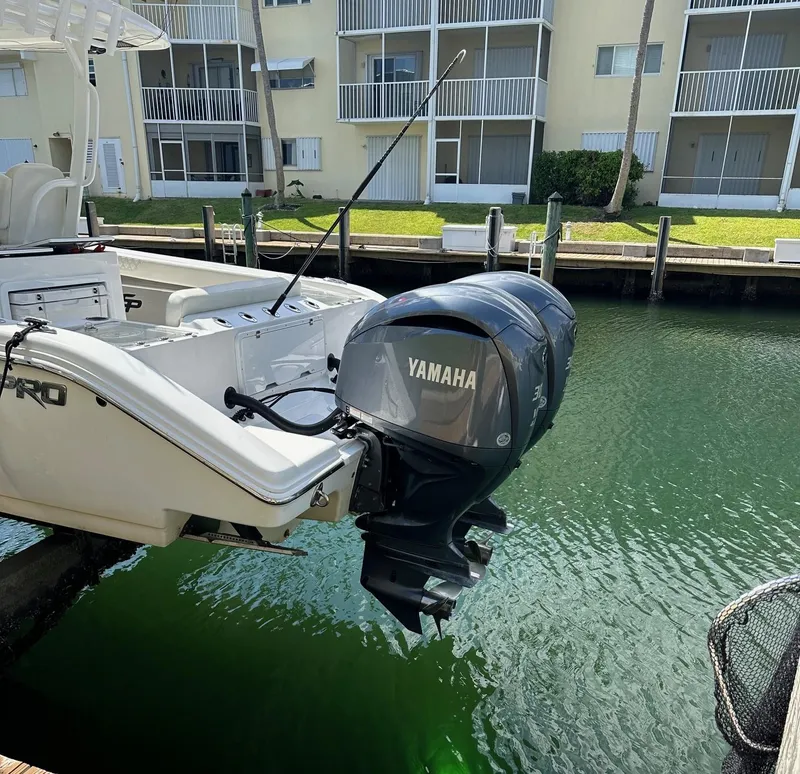 Slide: The Image of 2022 Sea Pro 320 DLX Center Console with Yamaha outboard engine docked by waterfront. - 8