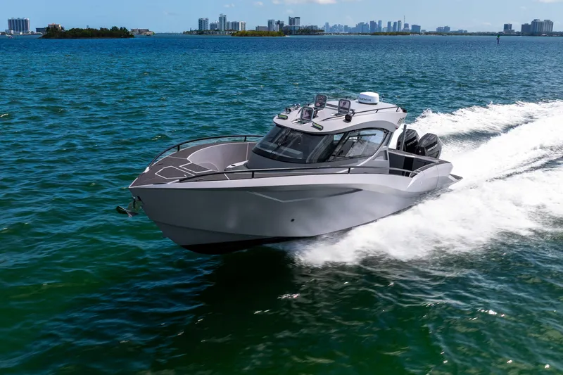 Slide: The Image of Sleek Novielli SERE 2025 boat cruising on blue ocean waters near city skyline. - 15