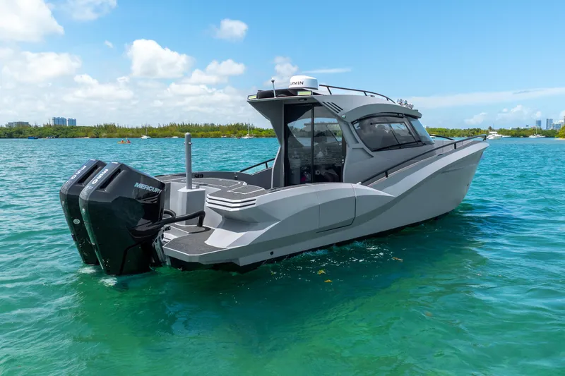 Slide: The Image of 2025 Novielli SERE boat on clear blue water, featuring dual Mercury engines. - 7