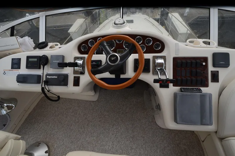 Slide: The Image of Cockpit of 2000 Sea Ray 420 Aft Cabin with steering wheel and control panel. - 11