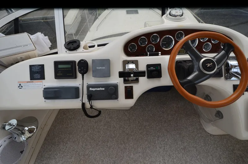 Slide: The Image of Cockpit of 2000 Sea Ray 420 Aft Cabin with steering wheel and navigation instruments. - 12