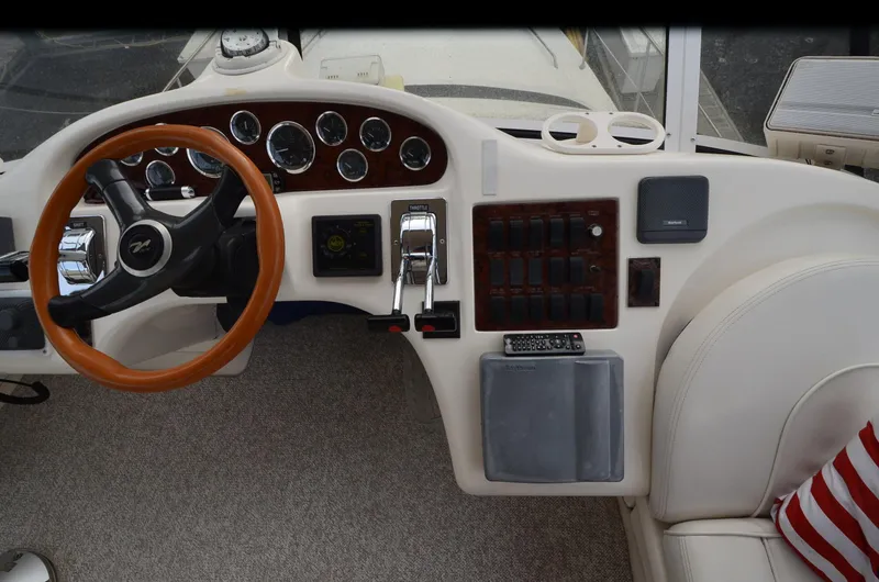 Slide: The Image of Helm of 2000 Sea Ray 420 Aft Cabin with steering wheel and control panel. - 13