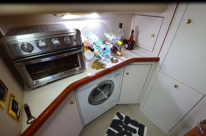 Slide: The Image of Kitchen area of 2000 Sea Ray 420 Aft Cabin with oven and washing machine. - 15