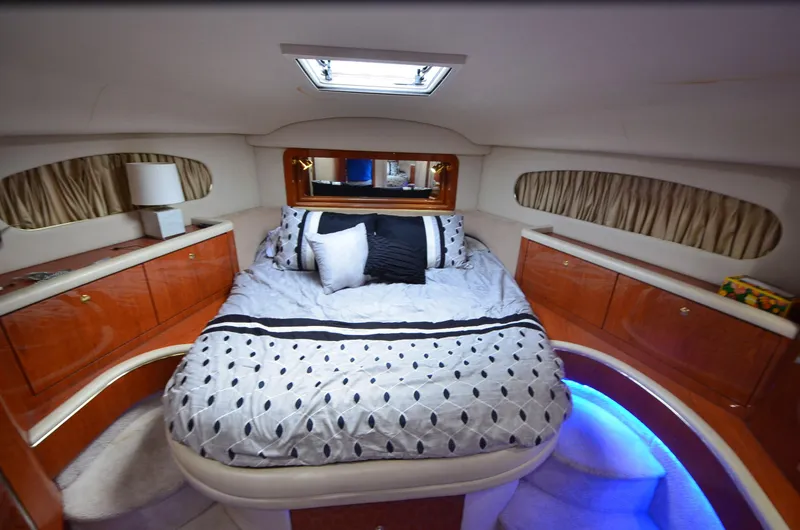 Slide: The Image of Luxurious bedroom interior of 2000 Sea Ray 420 Aft Cabin yacht with elegant bedding. - 16