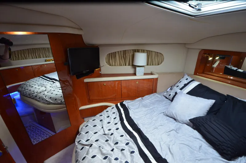 Slide: The Image of Luxurious cabin interior of 2000 Sea Ray 420 Aft Cabin yacht with cozy bedding. - 19