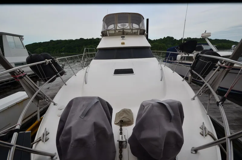 Slide: The Image of 2000 Sea Ray 420 Aft Cabin yacht docked at marina, surrounded by other boats. - 2
